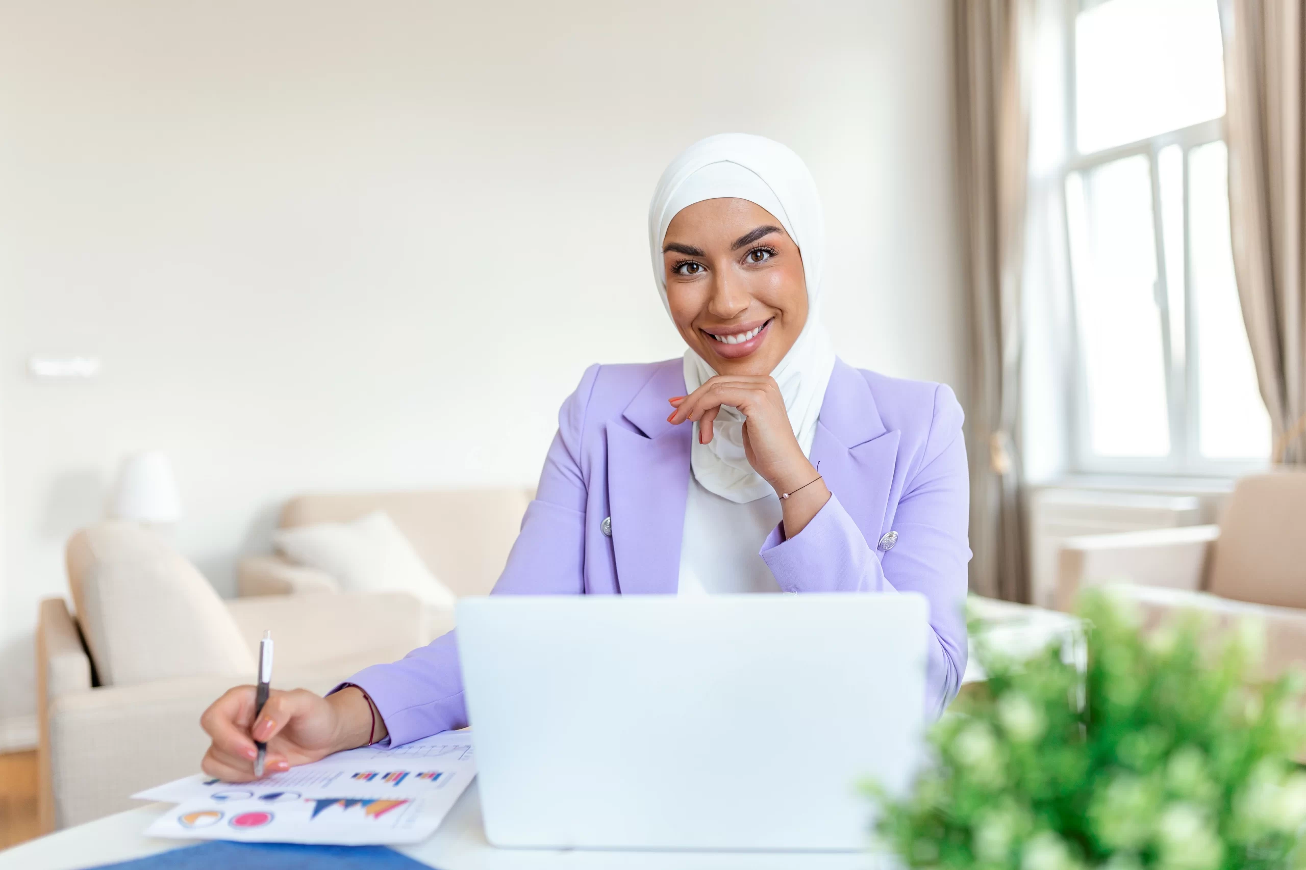 attractive-female-arabic-working-laptop-computer-paperworks-desk-arabian-businesswoman-working-home-dedication-technology-essential-getting-her-tasks-done